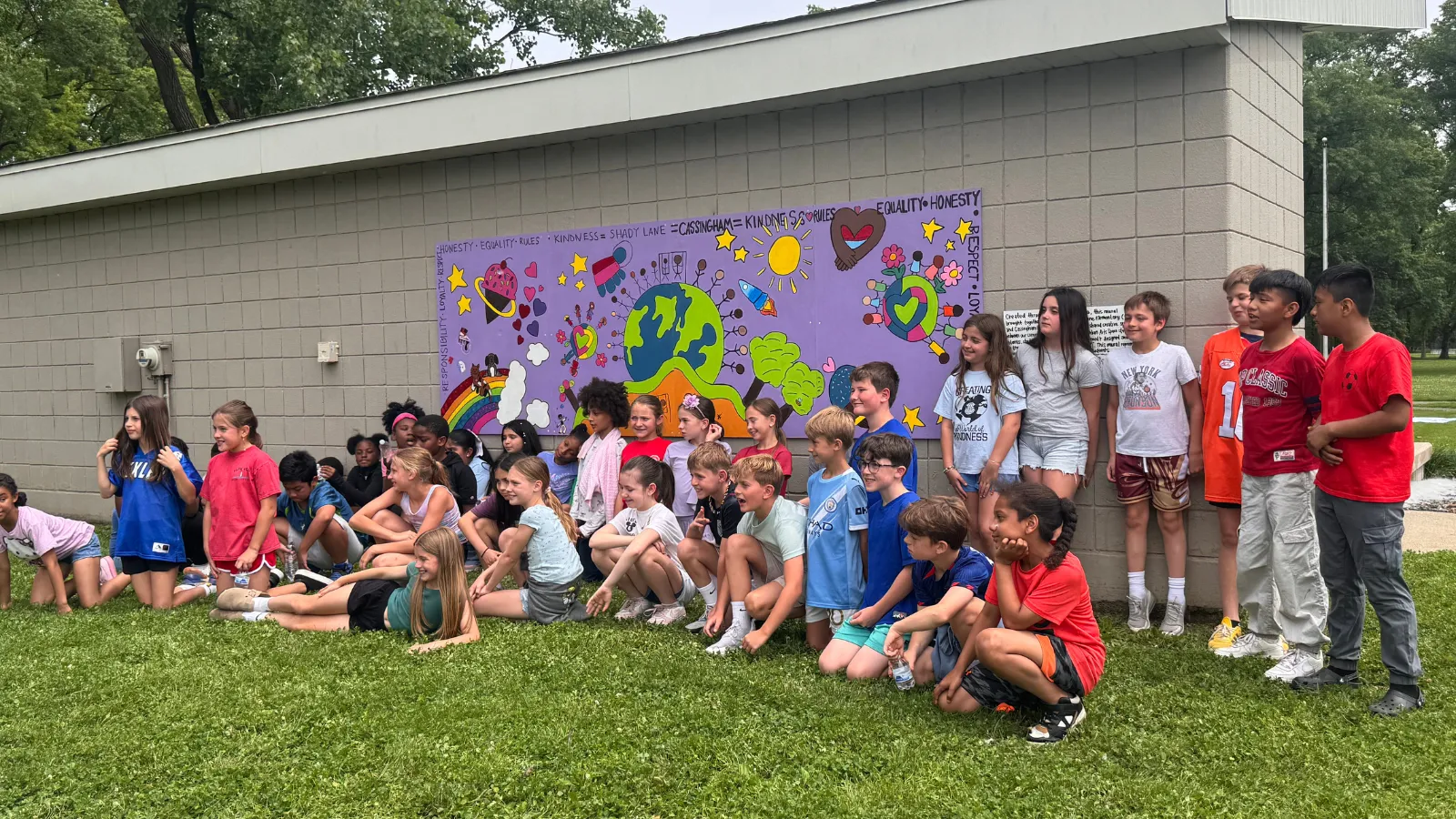 Group of kids in front of mural