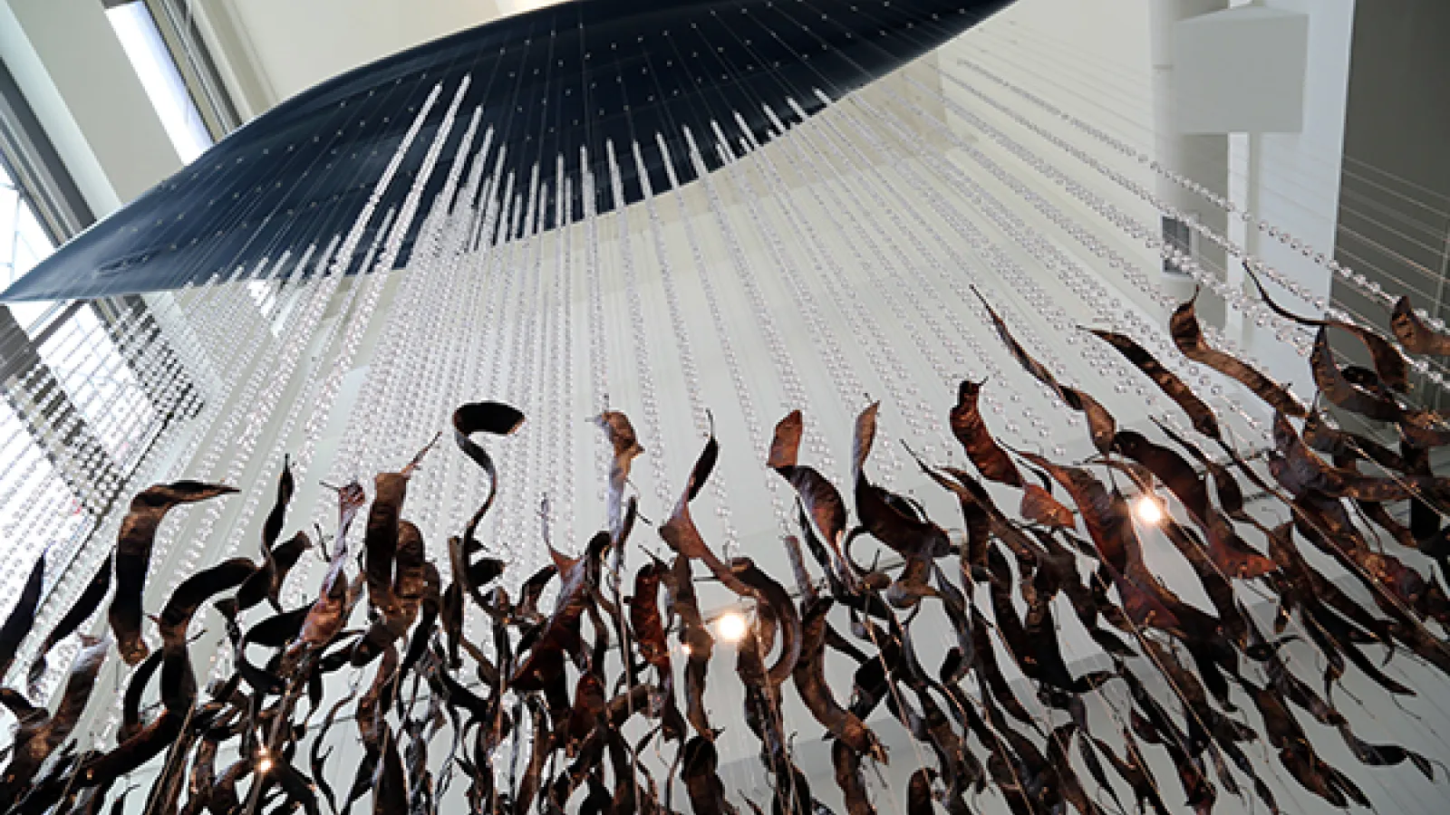 Catherine Bell Smith: "Life in the Balance," kayak, black locust seedpods, glass beads, sand, tire weights, and wire, 2015
