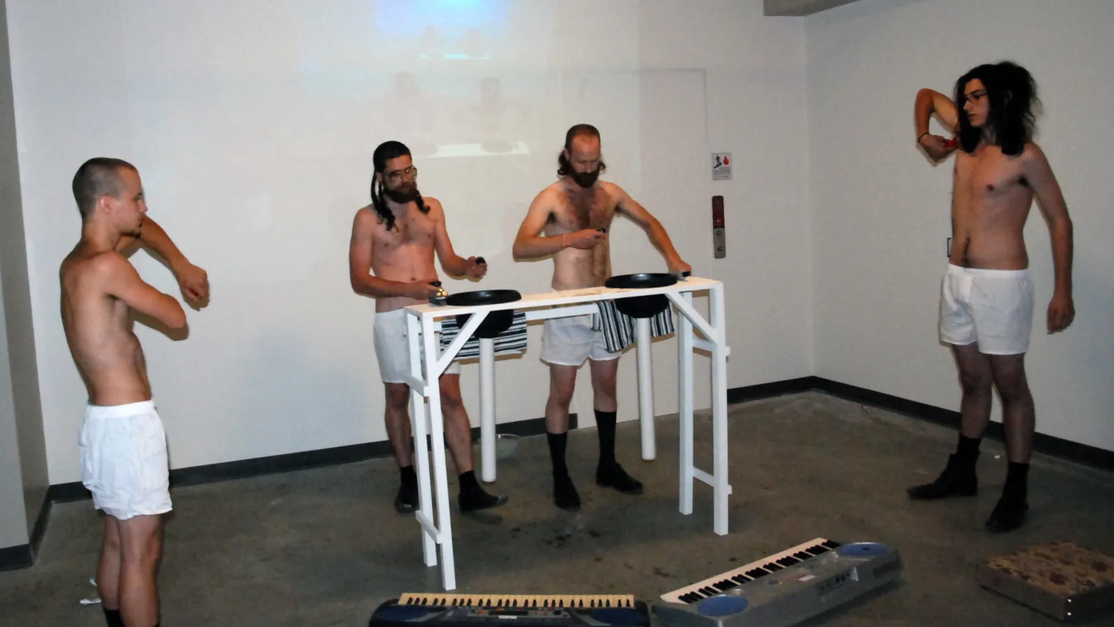 Chine-collé, Emergence: (Preparation), wood, plastic/glass bowls, PVC, toothbrushes, floss, water, keyboards, hair-clippers, suits, briefcases, hair