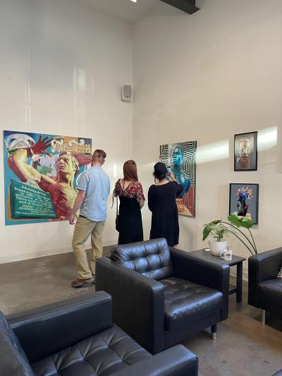 visitors admiring Arris's paintings