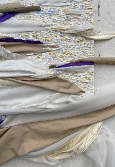 Close up of fabric art piece by Madeline with purple, white, and beige fabric