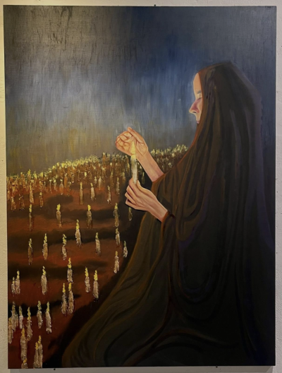Oil figure holding candle with lit candles in the field of the background
