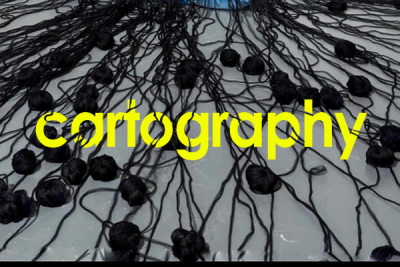 Black yarn stung across the floor with bright green text that reads "cartography"