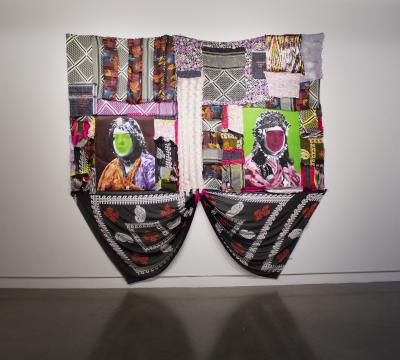 A fiber art piece by Nuveen Barwari featuring large colorful portraits of kurdish women surrounded by traditional fabrics