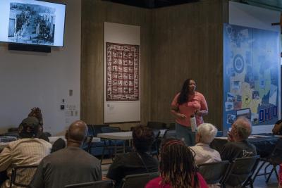 Tyiesha Radford Shorts speaking with a TV in the background