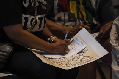 A hand writing notes on a piece of paper 