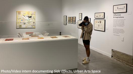A Photo/Video Intern photographing the "Side Effects" exhibition at Urban Arts Space.