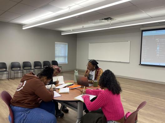 Ajanae teaching three young poets