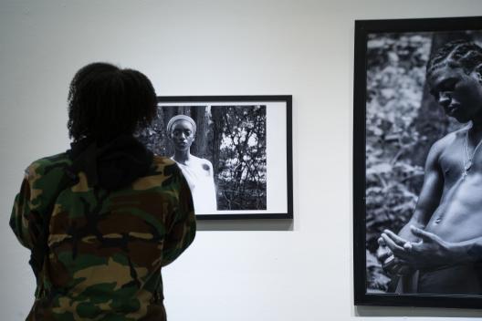 visitors in front of photographs