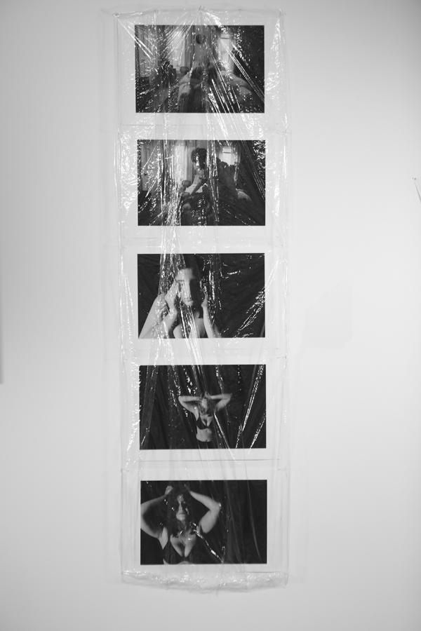 5 black and white images hung on a wall