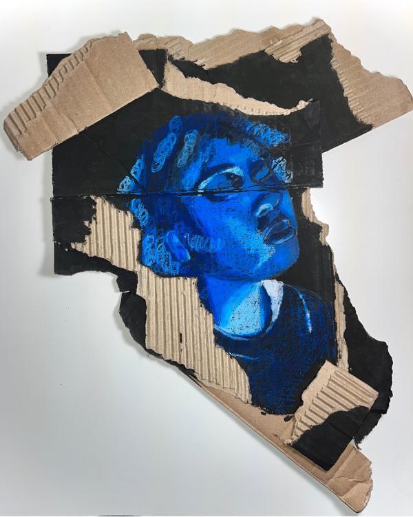 Multimedia art of a blue head on cardboard
