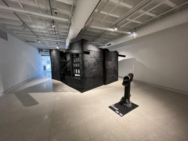 Installation at Hopkins: a house with black paint and a mailbox outside of it