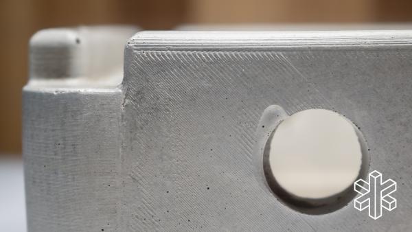 A close-up of the top corner of the concrete grill