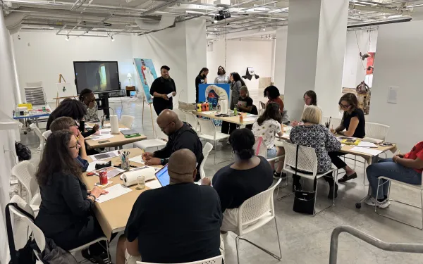 tyiesha teaching a poetry workshop at the gallery to a crowd of people