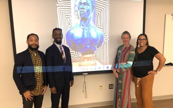 Terron Banner (left), Arris' J. Cohen, Merijn van der Heijden and Monica Stigler are pictured in front of a slide of Cohen's work.