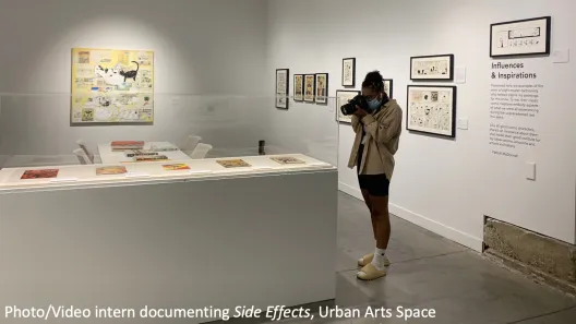 A Photo/Video Intern photographing the "Side Effects" exhibition at Urban Arts Space.