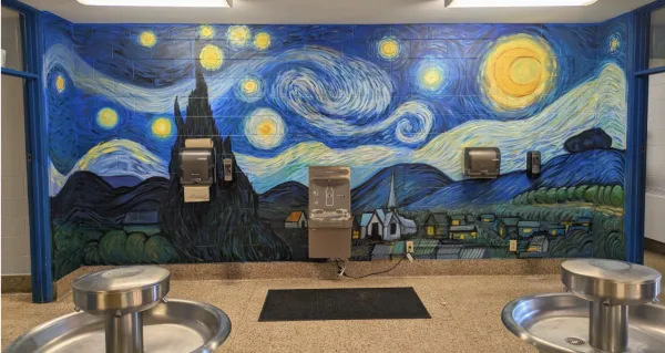 A school bathroom wall with a Starry Night mural