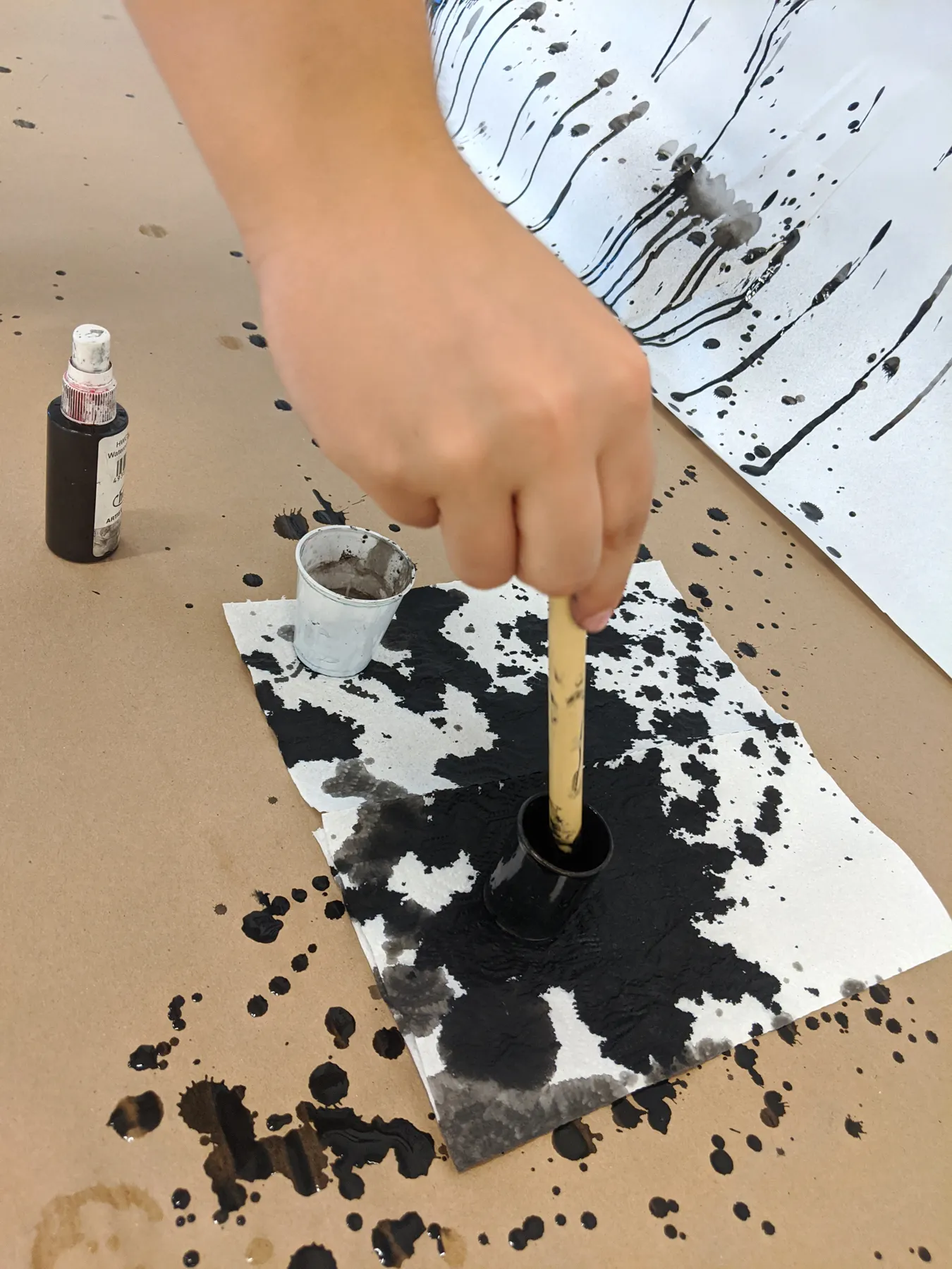 Rapid Fire Text: image of person wetting brush with ink