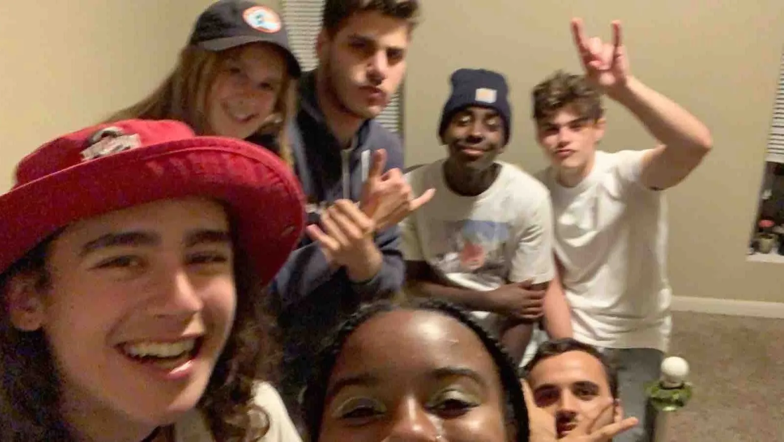 group of six friends smiling 