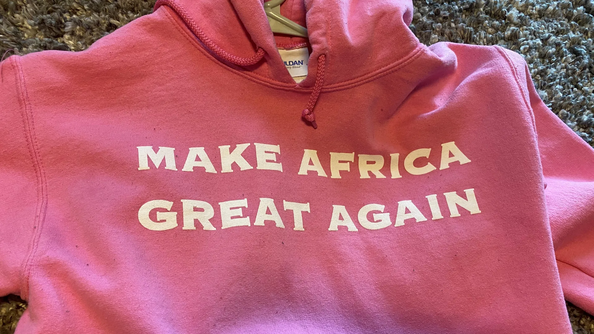 pink sweatshirt that states, "MAKE AFRICA GREAT AGAIN"