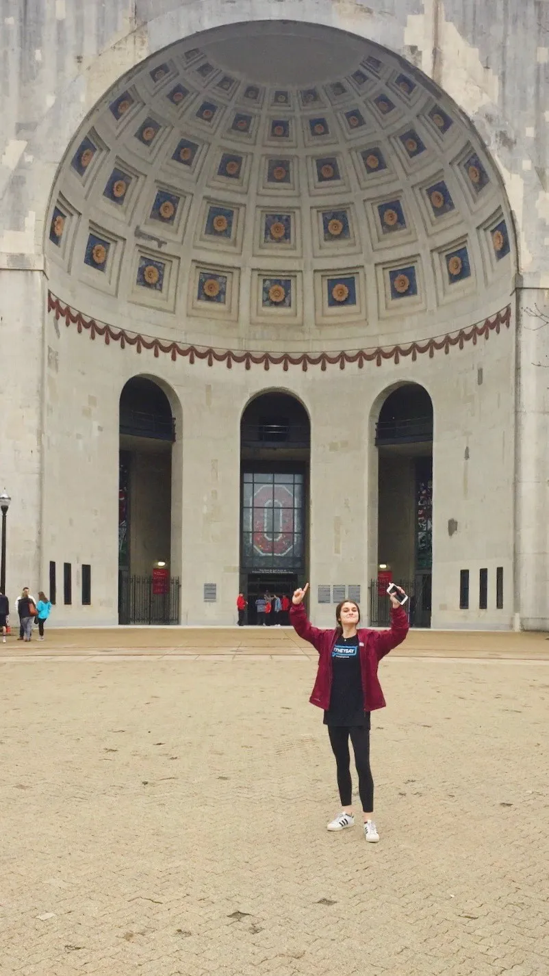 woman standing outside of Ohio State football stadium 