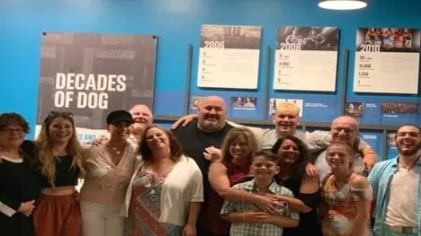 family smiling and posing for a photo