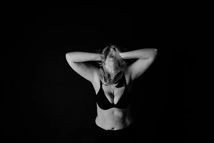 black and white image of woman holding face