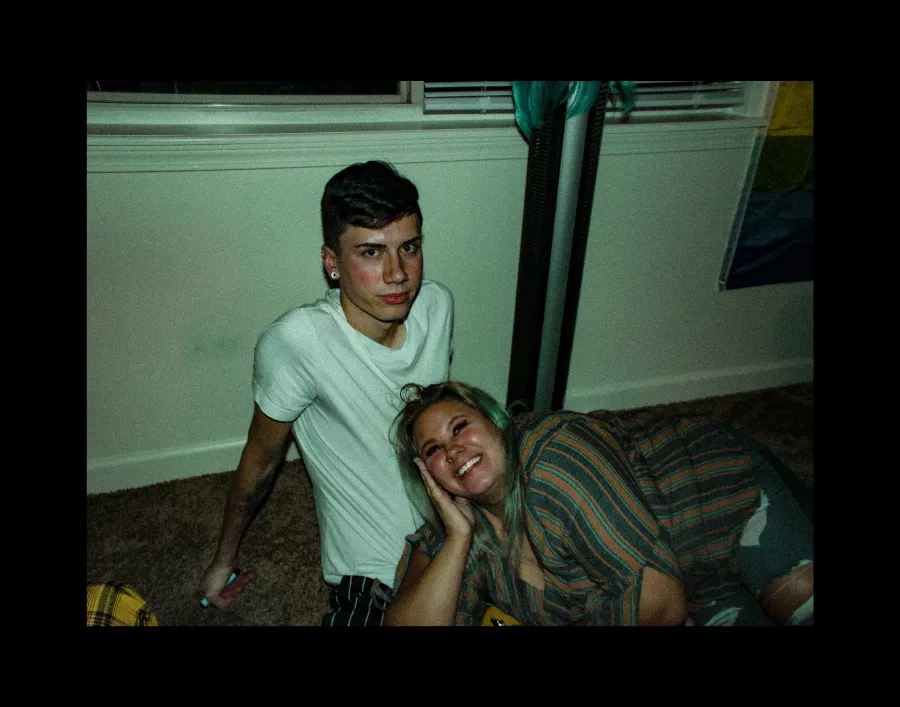 man and woman sitting together on the floor