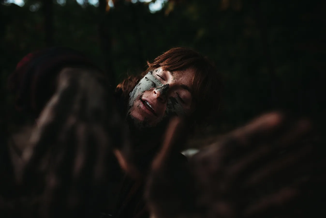 smiling woman with mud on her face
