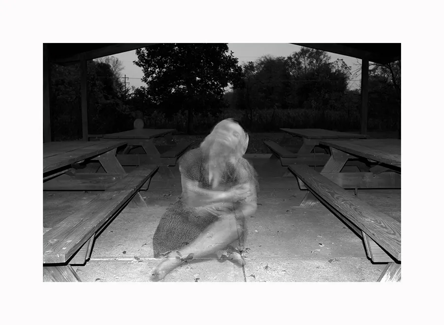 black and white woman sitting cross-legged
