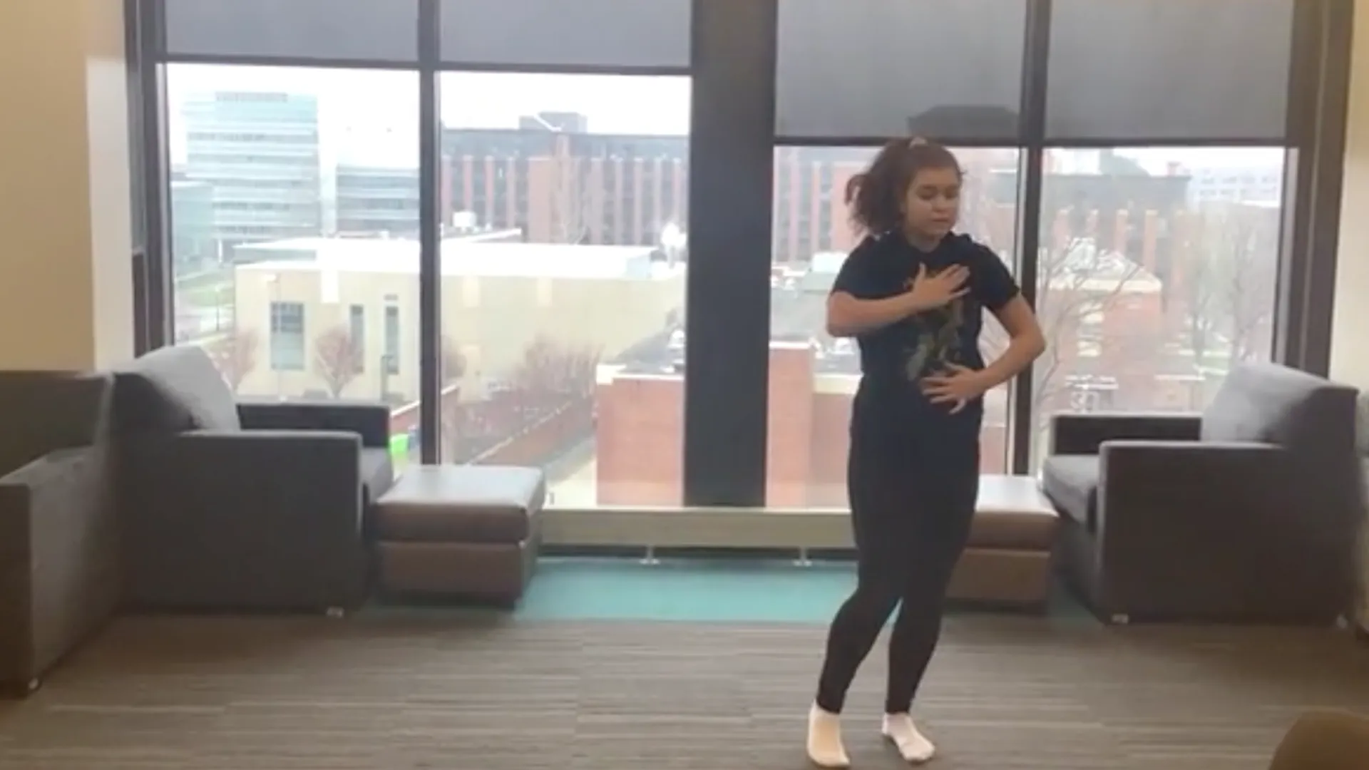 A dancer in a residence hall common area.
