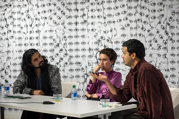 lllya Mousavijad and two other artists discussing the artworks displayed in the Exhibition titled Iran: Deciphering Violence and Resistance. 