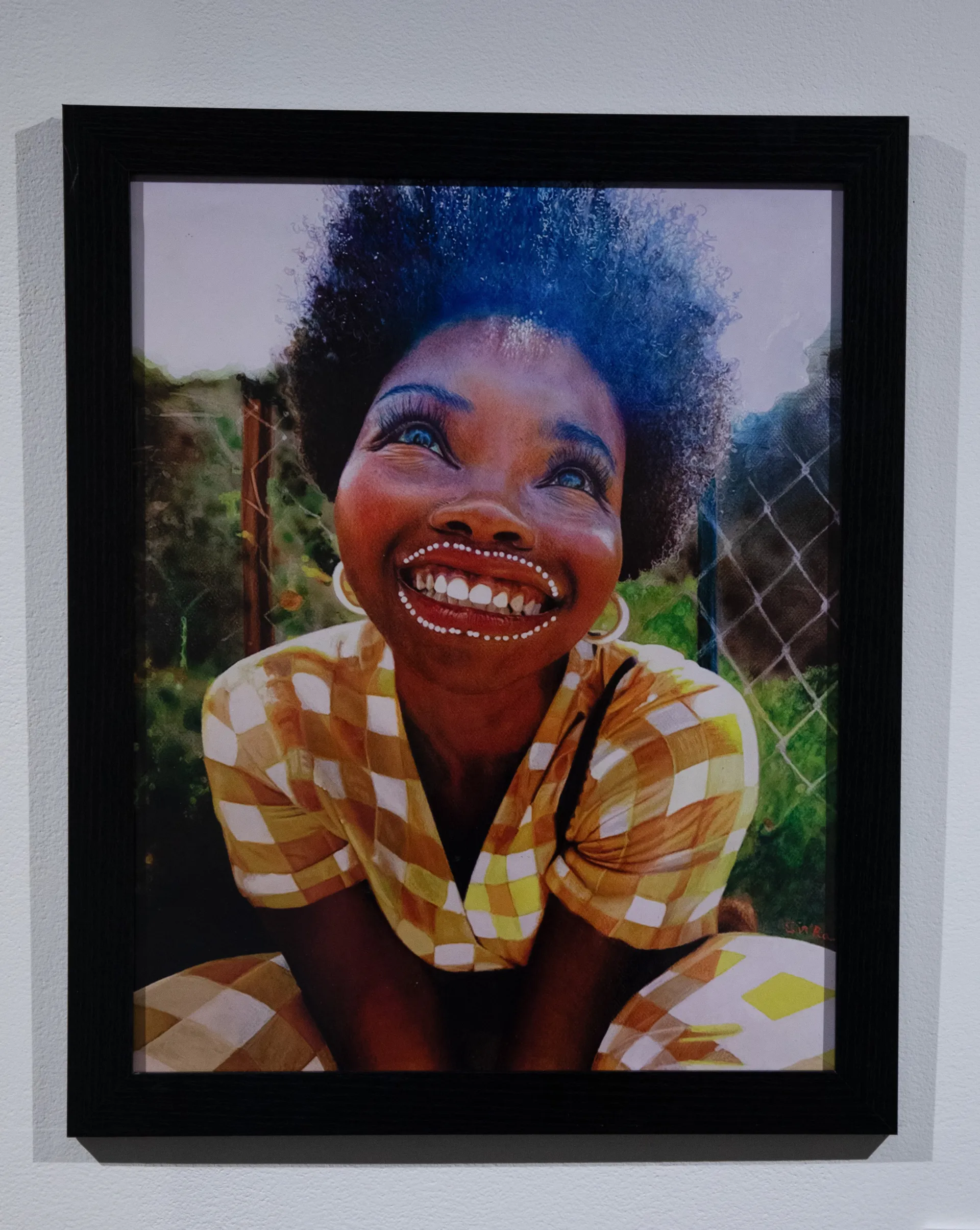 Print of an African American woman looking up and smiling in a seated position 