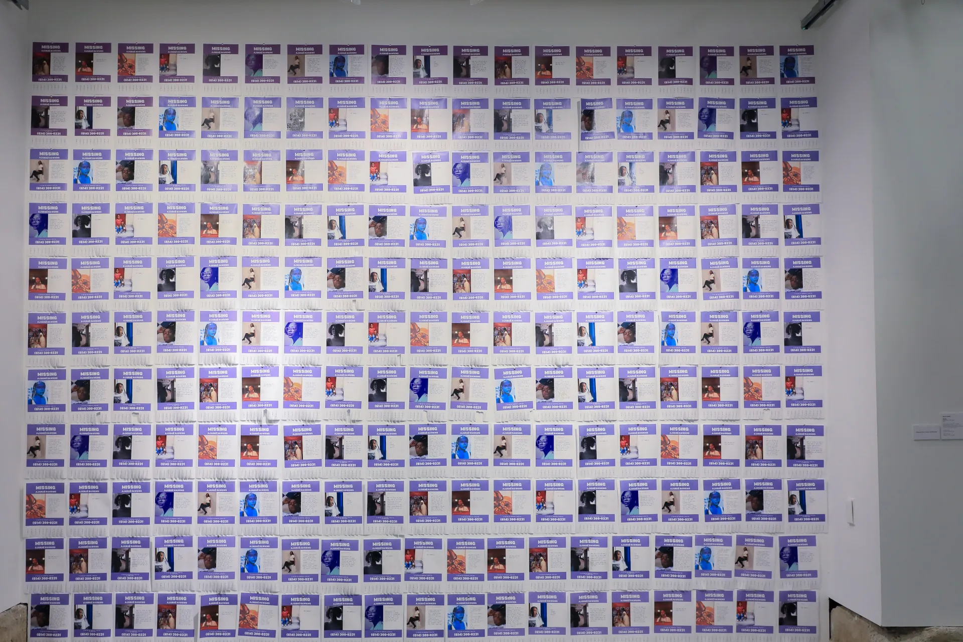 Hundreds of missing posters with different photos of Ajanaé Dawkins arranged into a square.