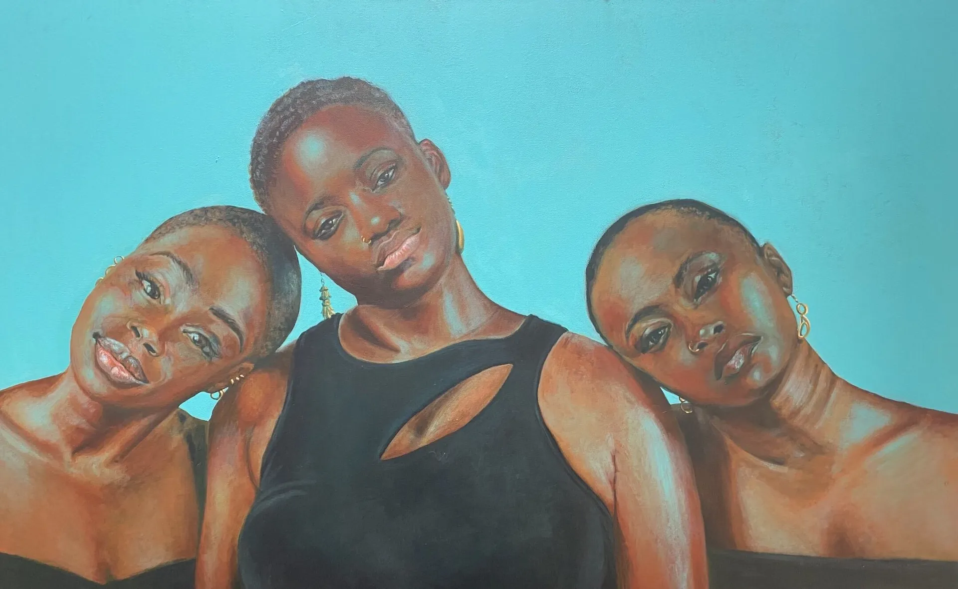 three women of color with short hair, black shirts, and gold earrings in front of a light blue background
