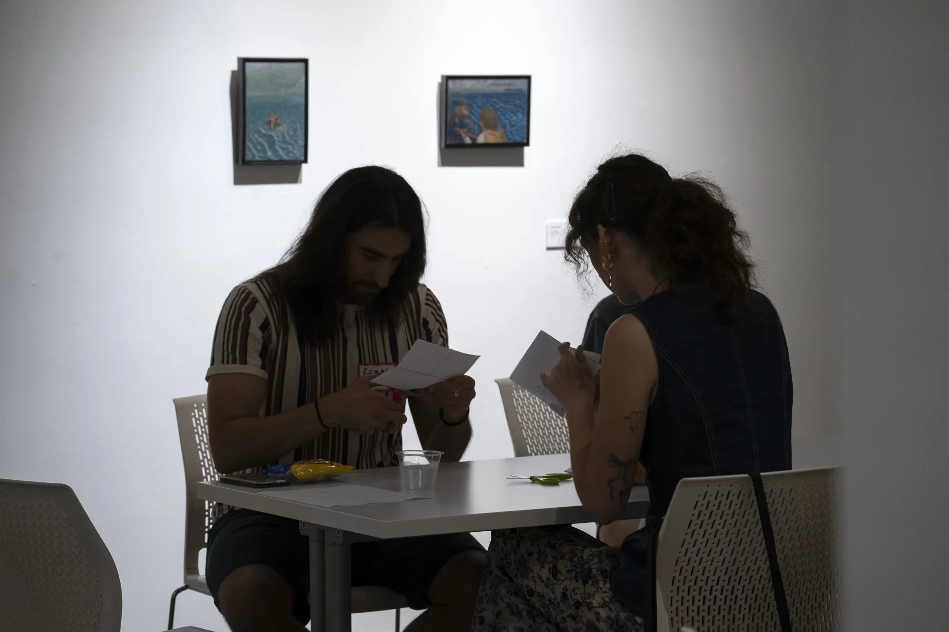 Two figures carefully cut one-page zines