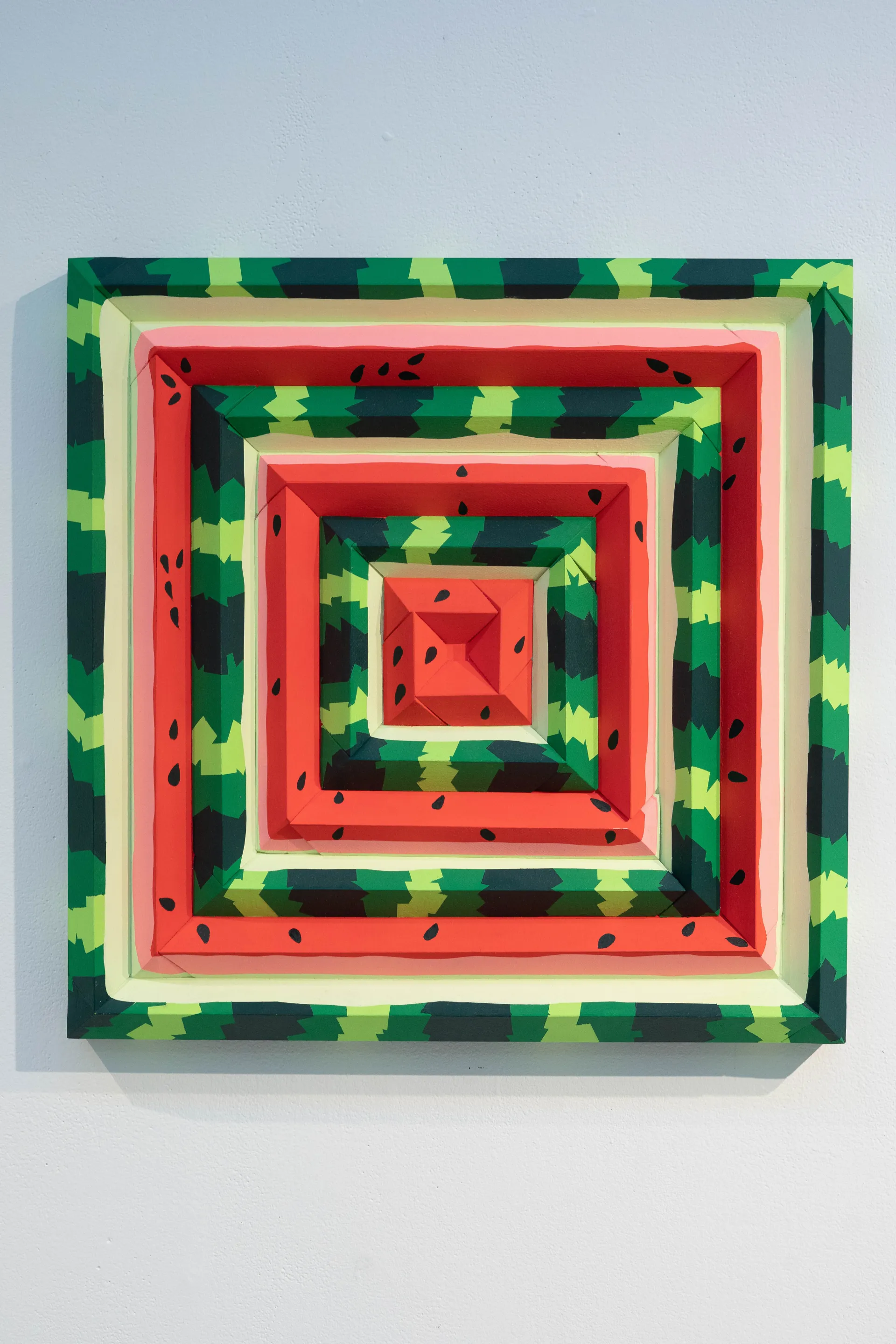 square painting that mimics the patterns and colors of a watermelon