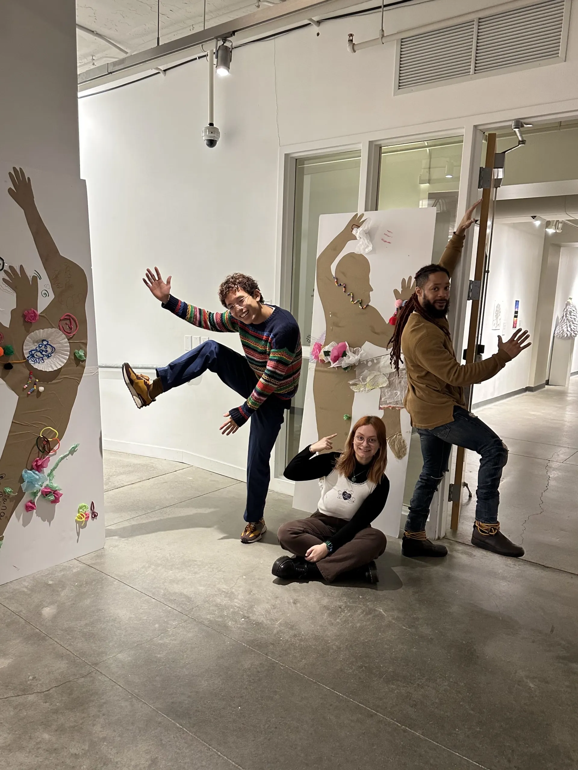 Terron posing with two interns in the gallery