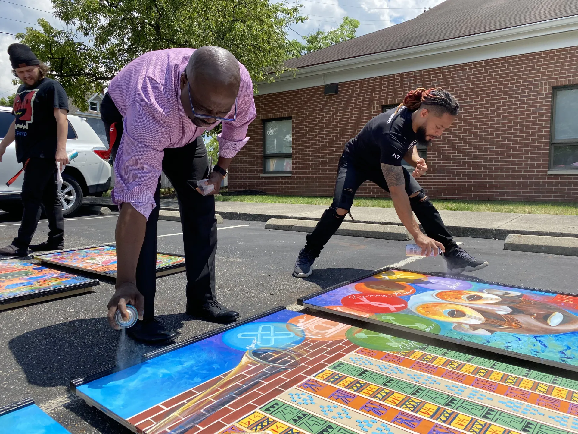 terron helping to paint a mural