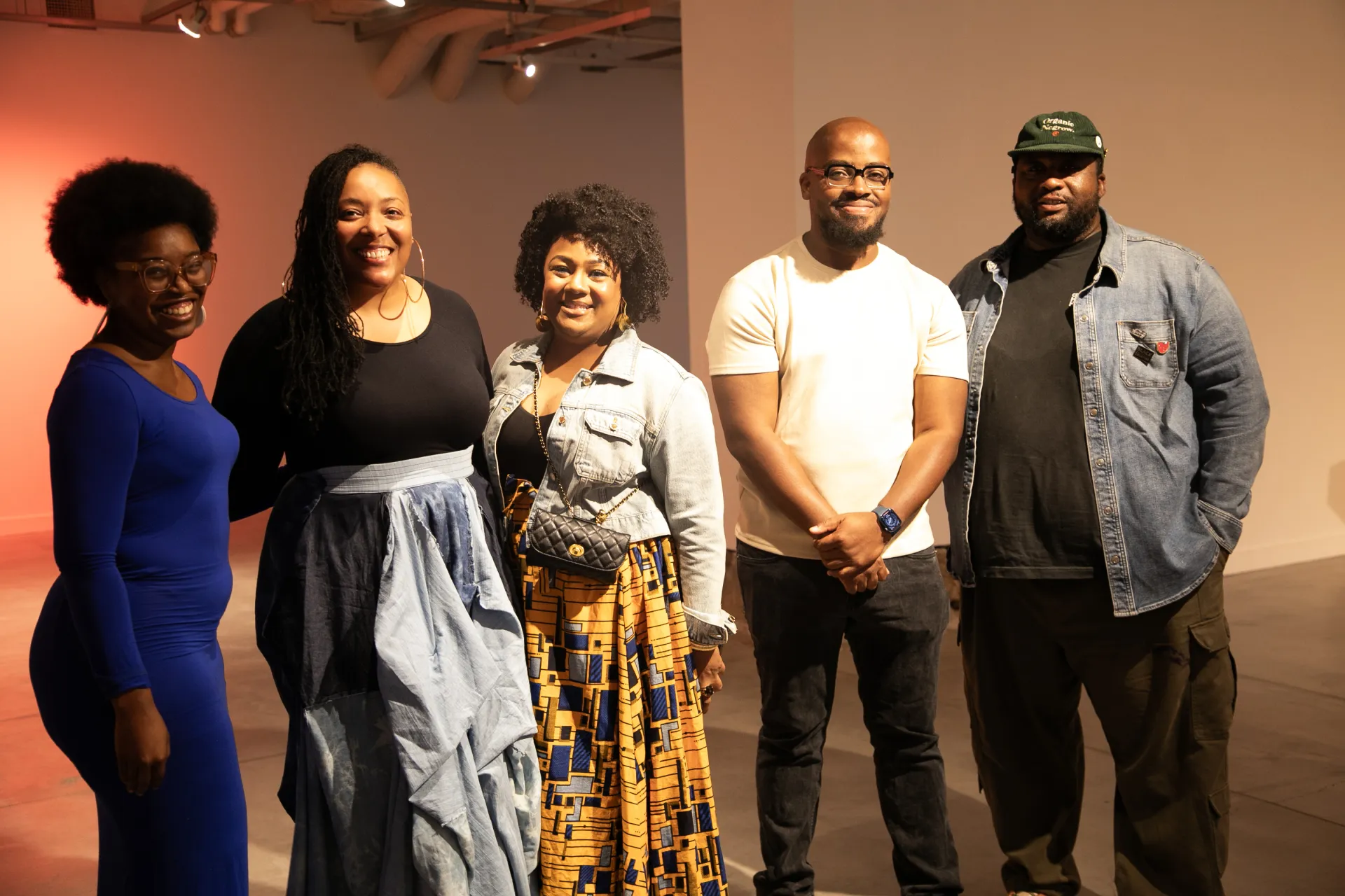 Five artists smiling at the camera 