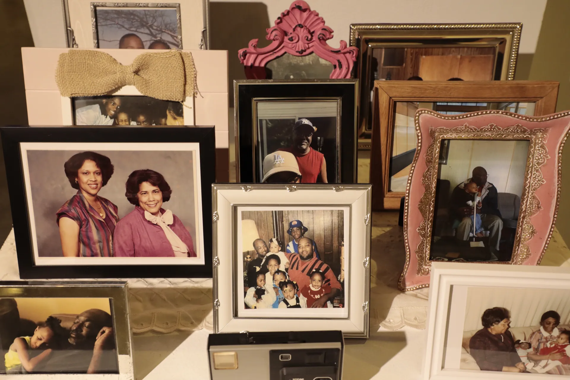 Multiple frames sit in front of and behind each other, depicting children with their family 