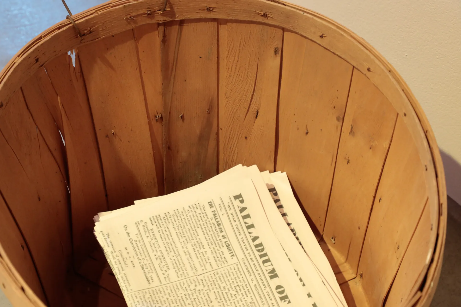 Inside of a basket with copies of the Palladium of Liberty newspaper