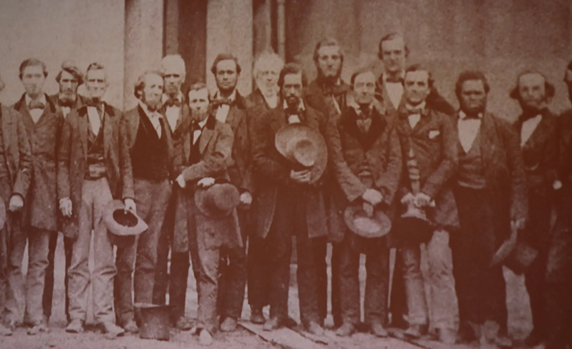 A vintage photograph of a group of men staring into the camera 