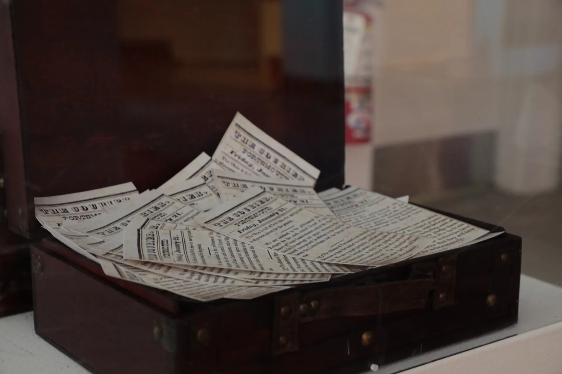 A wooden briefcase with pamphlets inside 