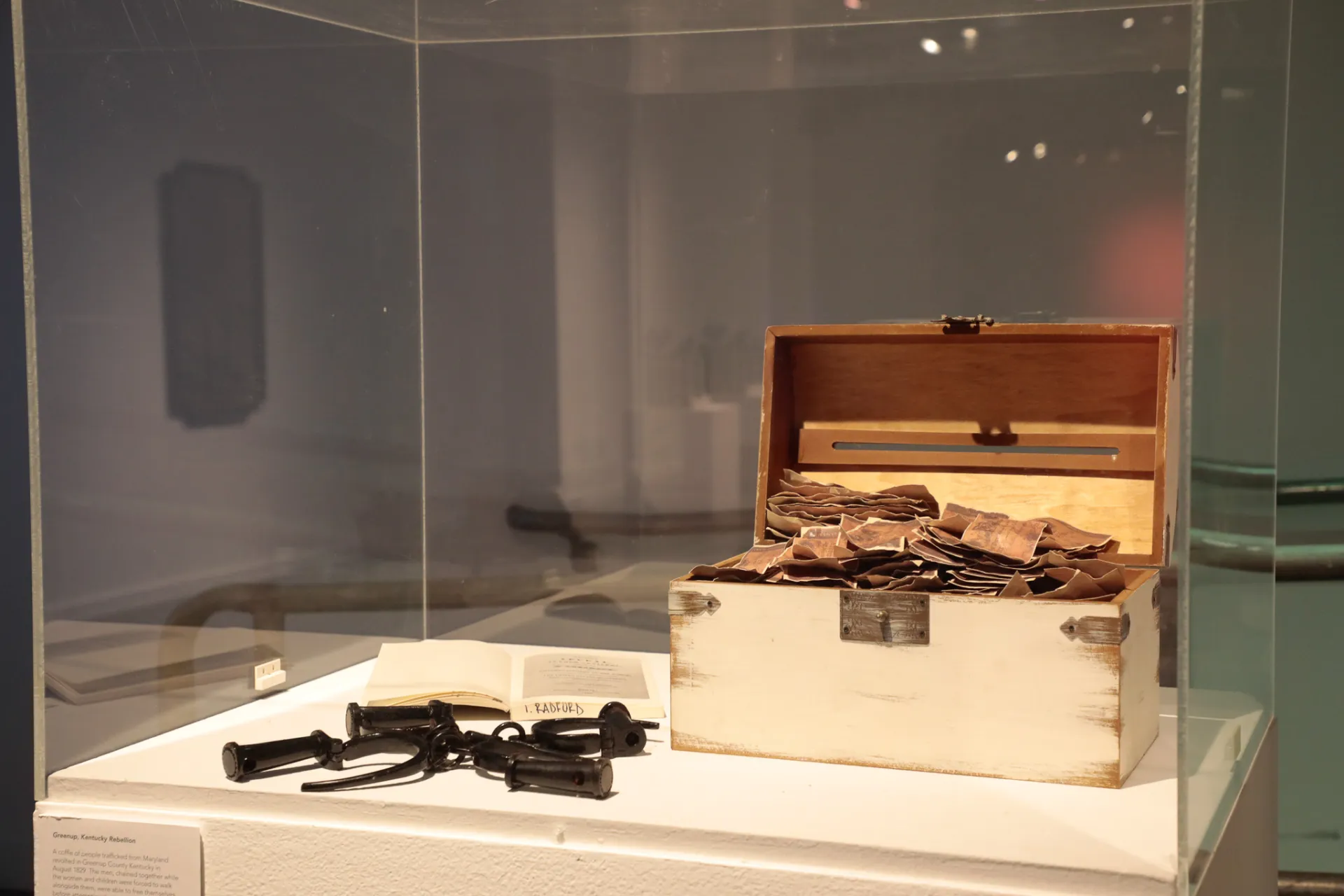 An open wooden box full of money 