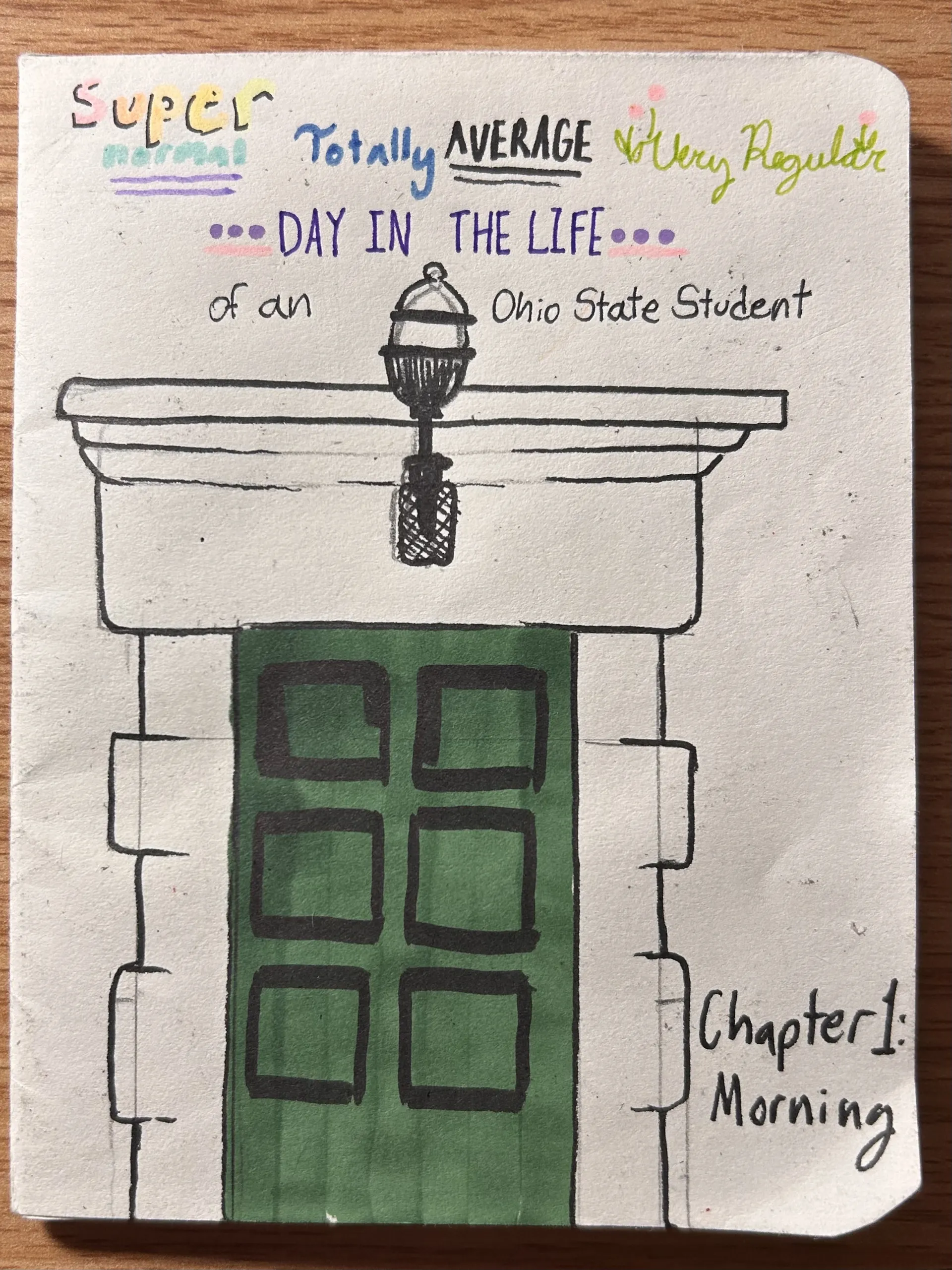 The cover of a handmade comic titled "Super Totally Average Very Regular DAY IN THE LIFE of an Ohio State Student." It features a drawing of a green arched door under a stone portico and a lamp, with "Chapter 1: Morning" written in the corner.