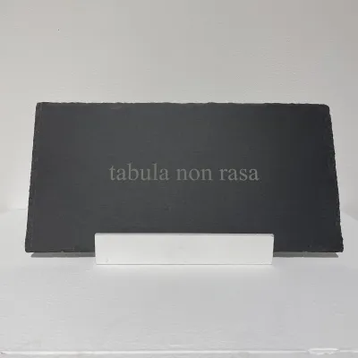 dark gray slab with the words tabula non rasa engraved on it