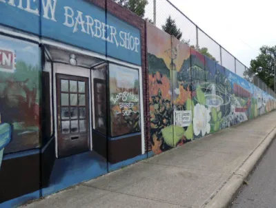 Store front of Longview BarberShop and a mural with bright colors