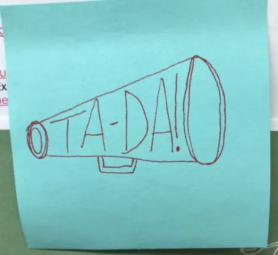 A light blue post-it note with a drawing of a megaphone that says "Ta-Da!"