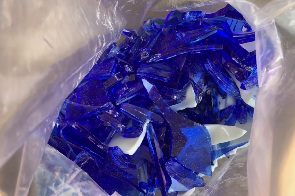 Bright blue broken glass in a bag.